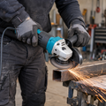 1200W variable speed angle grinder being used by a worker to cut steel in a professional workshop