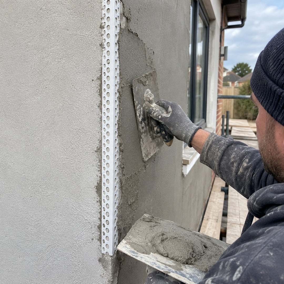 25x25mm white PVC render corner bead being installed on an external rendered building corner by a plasterer