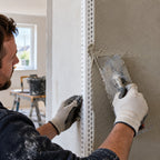 23x23mm white PVC universal render corner bead being installed on an internal plastered corner by a plasterer