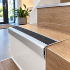 A03 30mm anodised aluminium self adhesive door threshold installed between wood flooring and tiled flooring