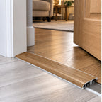 A13 40mm aluminium wood-effect self adhesive door threshold installed between two finished floors at a residential doorway