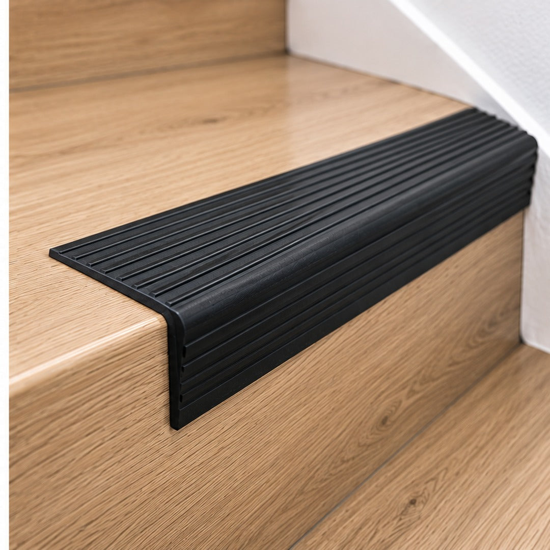 Close-up of A32 65x42mm anodised aluminium non-slip ribbed stair nosing fitted securely over a stair edge