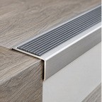 A42 41 x 26.6mm anodised aluminium non slip ribbed stair nosing shown installed on a wood-look stair tread