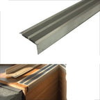Aluminium step tread with rubberized surface, showing installation on a staircase.